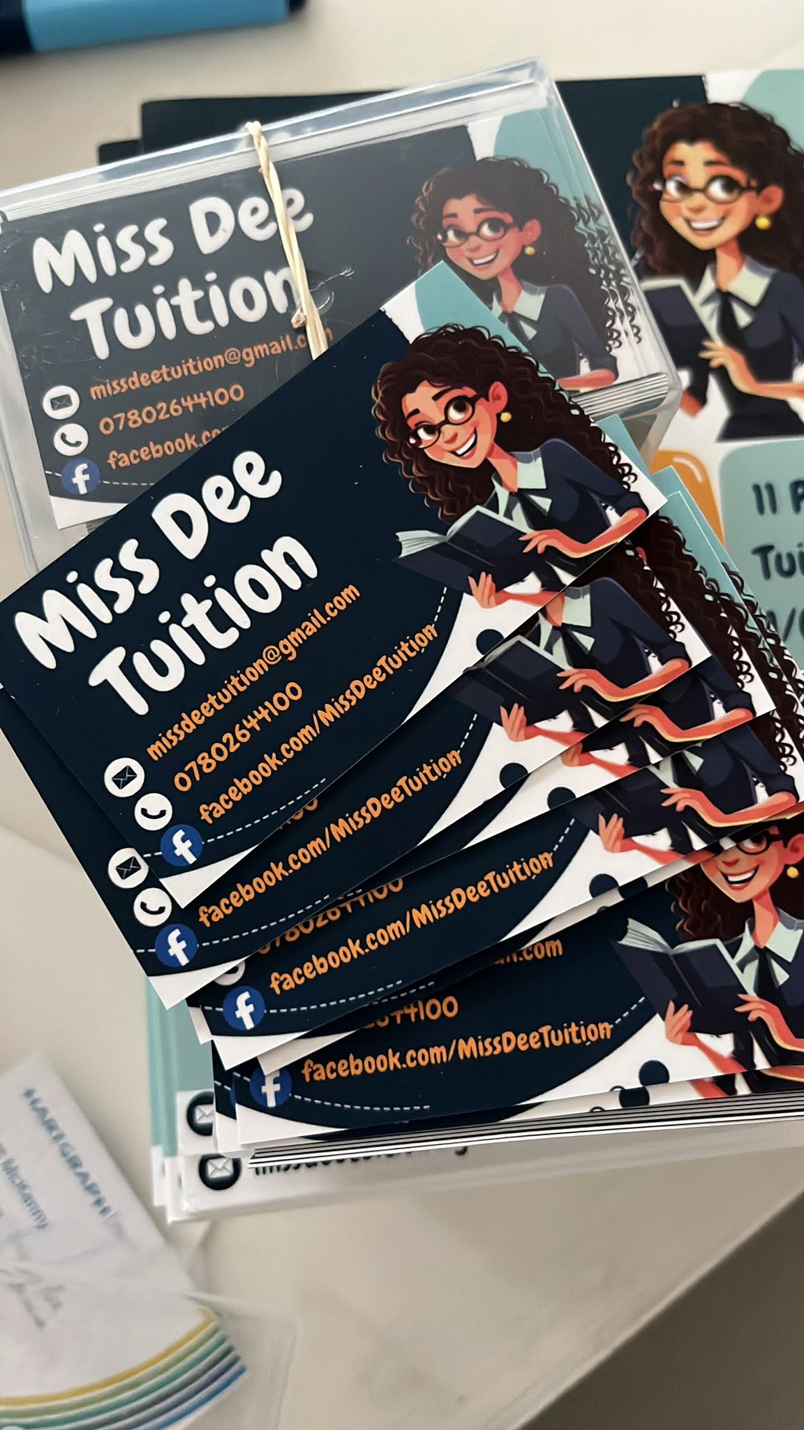 Stack of Miss Dee Tuition business cards