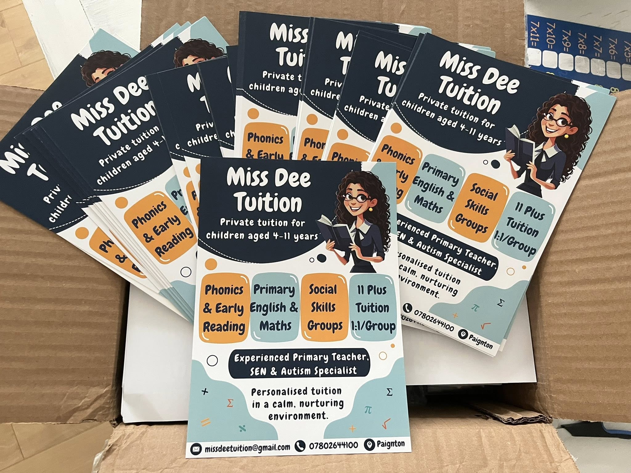 Stack of Miss Dee Tuition flyers and marketing materials